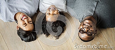 Diverse family lying on wooden floor design space Stock Photo