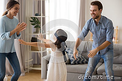 Diverse family playing hide and seek at home Stock Photo