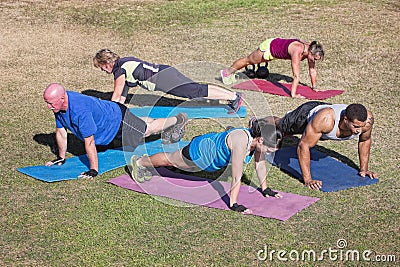 Diverse Group Doing Push-Ups Stock Photo