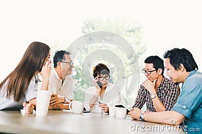 Diverse group of five Asian business person in team meeting at coffee shop or modern office. Strategic brainstorm, small business Stock Photo