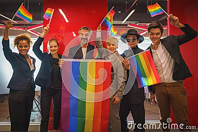 Diverse group of lgbtq people with rainbow flag on hand team up together Stock Photo