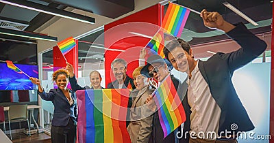 Diverse group of lgbtq people with rainbow flag on hand team up together Stock Photo