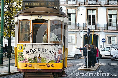 Diverse group of people gathered on a city street in front of a trolley track, Lisbon, Portugal Editorial Stock Photo