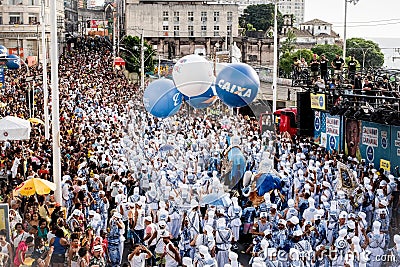 Diverse group of people joyfully marching in a parade, with blue clothes and balloons Editorial Stock Photo