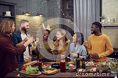 Diverse Group of Young People Enjoying Dinner Party Stock Photo
