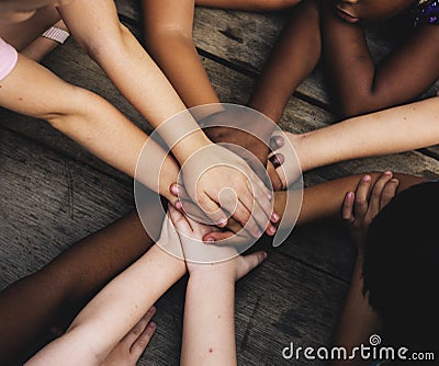 Diverse hands are join together on the wooden table Stock Photo