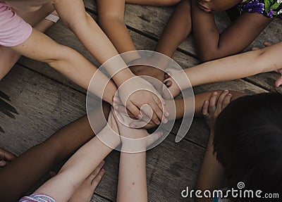 Diverse hands are join together on the wooden table Stock Photo