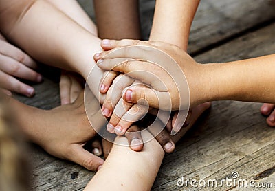 Diverse hands are join together on the wooden table Stock Photo
