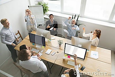 Diverse happy office team launching paper planes together, top v Stock Photo