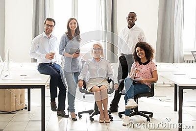 Diverse happy staff employees group posing for portrait in office Stock Photo