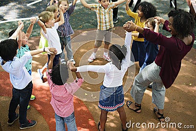 Diverse kindergarten kids arms raised Stock Photo