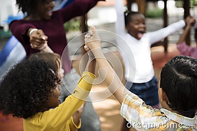 Diverse kindergarten students hands up together Stock Photo