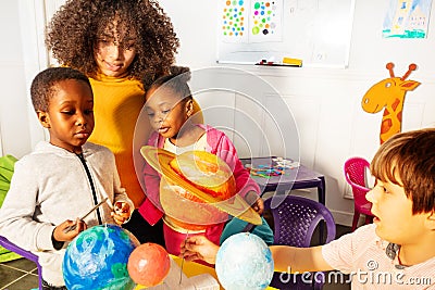 Diverse little kids learn solar system planets Stock Photo