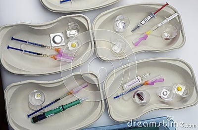 Diverse medication in glasses monodose along with insulin injectors in hospital Stock Photo
