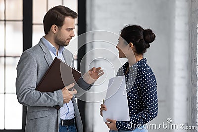 Diverse office colleagues met in office talking discussing project ideas Stock Photo