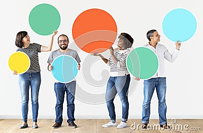 Diverse people holding colorful circles Stock Photo