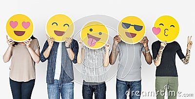 Diverse people holding happy emoticons Stock Photo