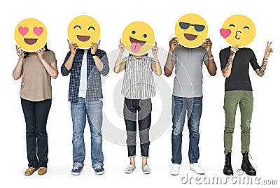 Diverse people holding happy emoticons Stock Photo