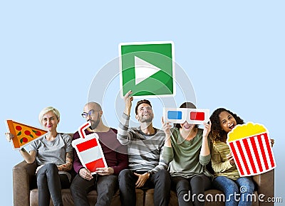 Group of diverse friends holding movie emoticons Stock Photo