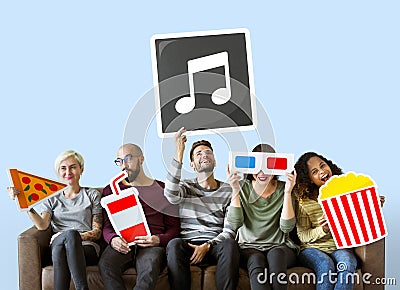 Group of diverse friends holding movie emoticons Stock Photo