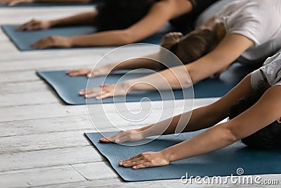 Diverse people practicing yoga close up, doing Child exercise Stock Photo