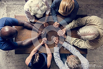 Diverse religious people praying together Stock Photo