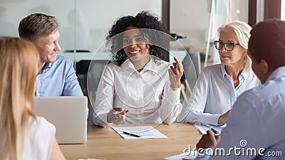 Multiracial employees talk discuss ideas cooperating at briefing Stock Photo