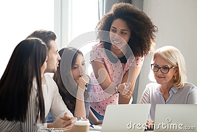 Diverse students workers team and mentor teacher involved in discussion Stock Photo