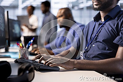 Diverse team of developers in data center identifying errors Stock Photo
