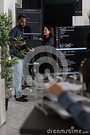 Diverse team of software programmers analyzing html code Stock Photo