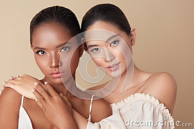 Diverse. Women Beauty Portrait. Multi-Ethnic Models With Natural Makeup And Perfect Skin Against Beige Background. Stock Photo