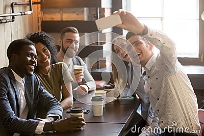 Diverse young friends taking selfie on smartphone together in ca Stock Photo