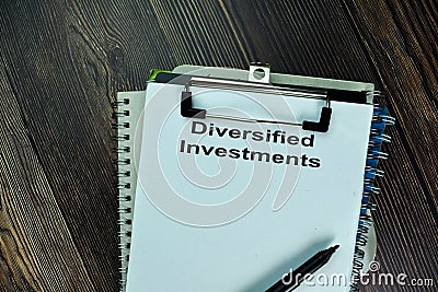 Diversified Investments write on a paperwork isolated on wooden table Stock Photo
