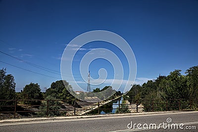 Diversionary channel bordered by trees seen from a bridge on a summer day Stock Photo