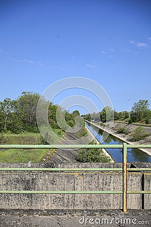 Diversionary channel on a sunny day seen on a bridge in the italian countryside Stock Photo