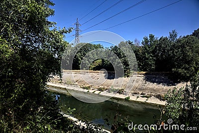 Diversionary channel with trees on a summer day in the italian countryside Stock Photo