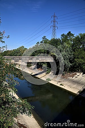 Diversionary channel with trees on a summer day in the italian countryside Stock Photo