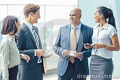 Diversity Asian business team with coffee in front of office Stock Photo