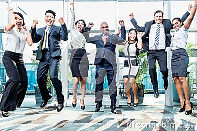 Diversity business team jumping celebrating success Stock Photo