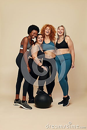 Diversity Models. Different Race And Size Women. Smiling International Friends In Sportswear Looking At Camera. Stock Photo