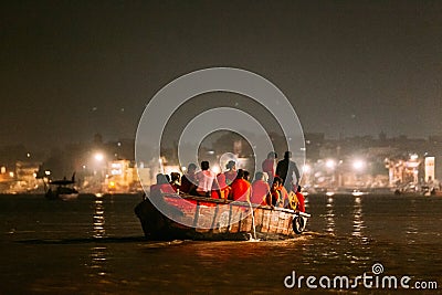 Diversity of people in the boat floating on the river are going to pray at Varanasi Ganga Aarti at holy Dasaswamedh Ghat. Editorial Stock Photo