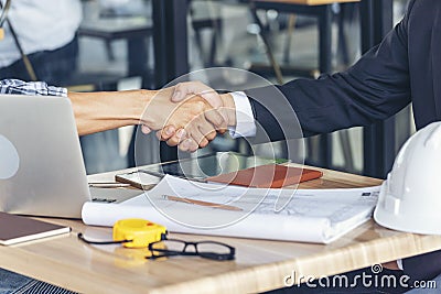 Diversity two business partners shaking hands together with business contract mergers and acquisitions. Close up honest hands Stock Photo