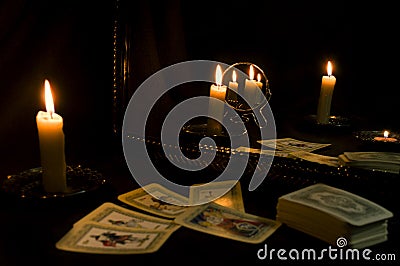 Divination by tarot cards by candlelight, fortune-telling with mirrors Stock Photo