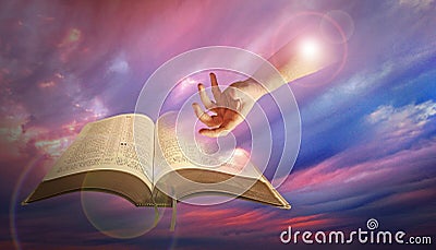 Divine hand of god with bible Stock Photo