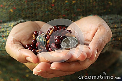 The Divine Mercy Rosary in young woman hands. Believe in God concept. Stock Photo