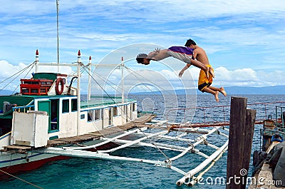 Diving Asian boys in port Editorial Stock Photo