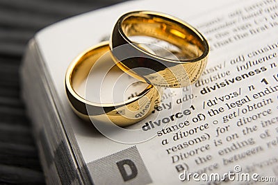 Divorce and separation concept. Two golden wedding rings. Dictionary definition. Stock Photo