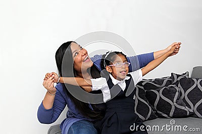 Divorced single mom and 4-year-old brunette Latina daughter enjoy quality time after school on Mother's Day Stock Photo