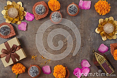 Diwali holiday border frame background with sweet traditional dessert, gift box and decorations. Top view, flat lay Stock Photo