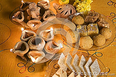 Diwali Lamps with Indian sweets (mithai) Stock Photo